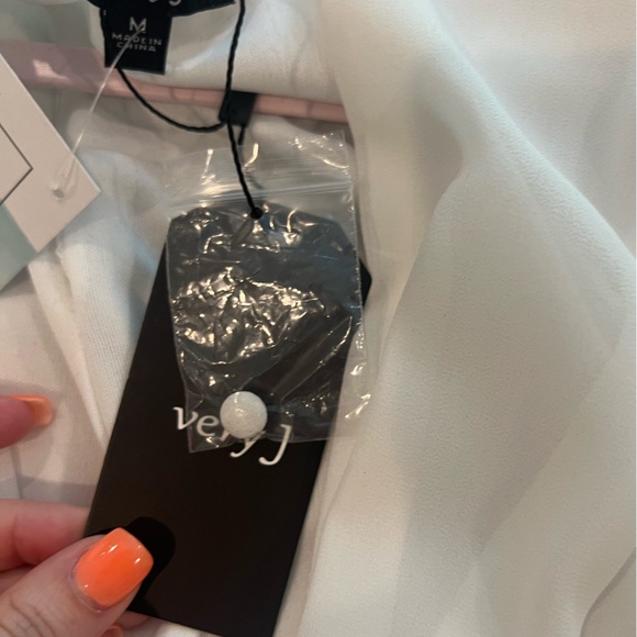 White Romper with Bell Sleeves, a Deep V Cut, and tie detailing - Picture 7 of 8